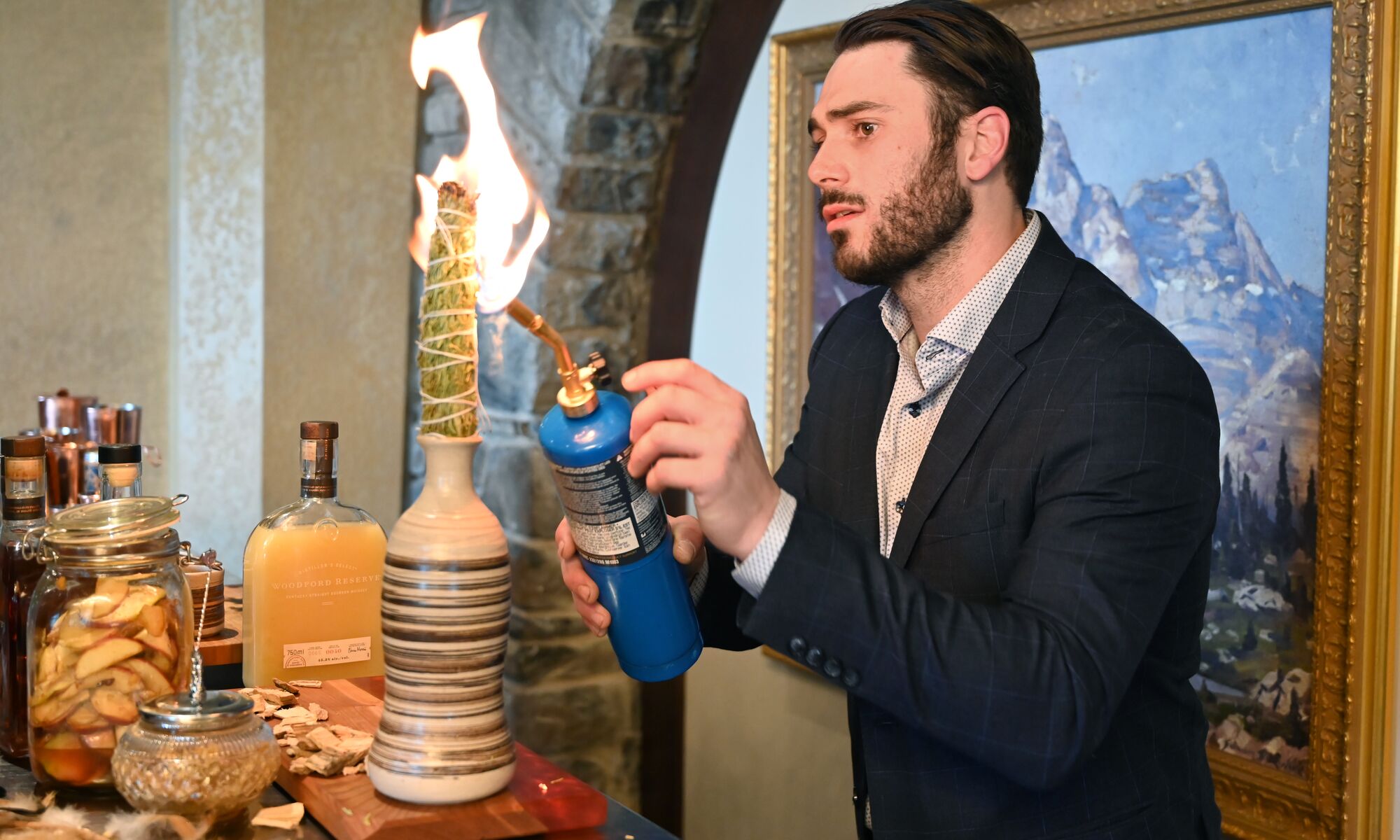 A bartender fires off a torch while making a fancy cocktail at the Banff Food & Cocktail Festival.